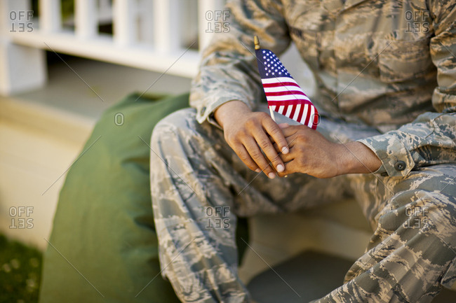 American flag held by a soldier.