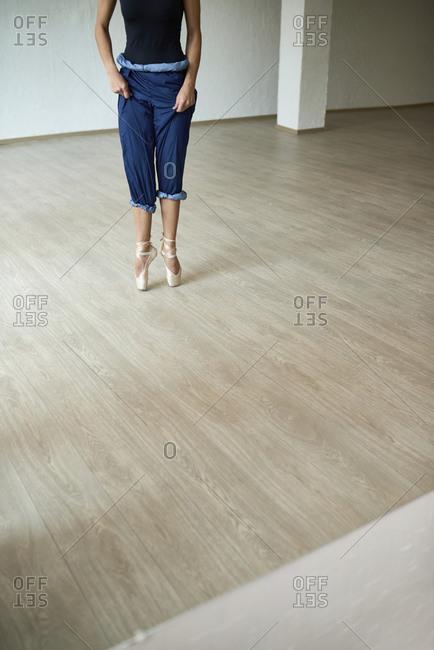 Low section of ballet dancer standing on toes at dance studio