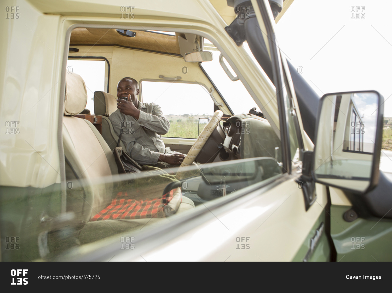 Park ranger talking on CB radio while sitting in car