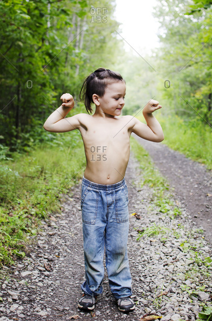 Young boy flexing his muscles
