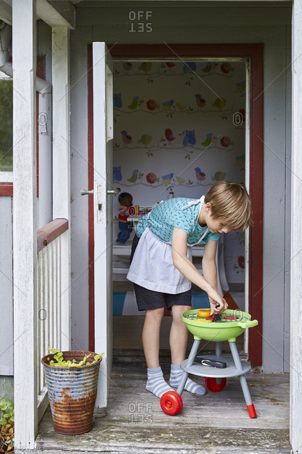 Boy playing with toy barbecue