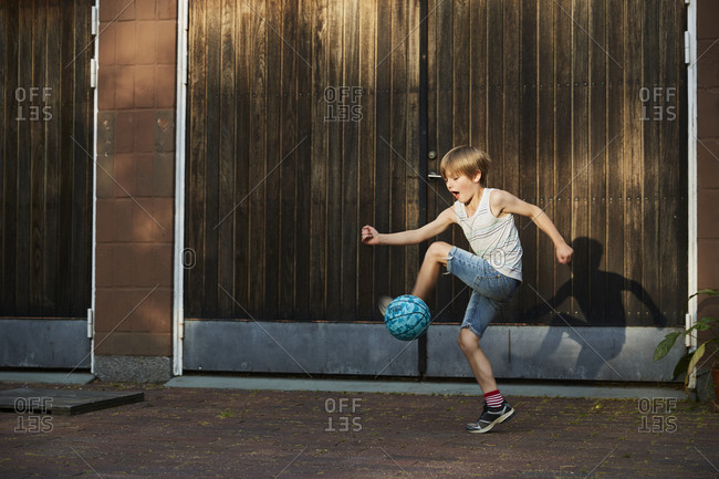 Boy kicking ball