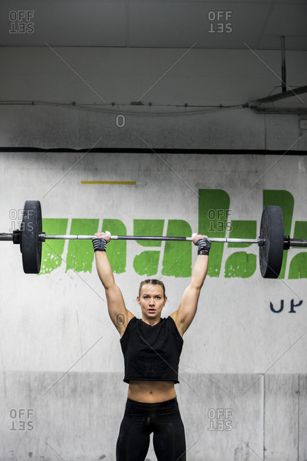 Woman lifting barbell in gym