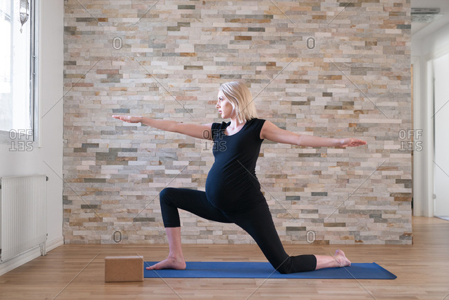 Heavily pregnant woman in yoga position