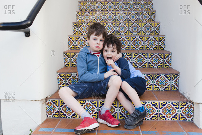 young boy grabbing little brother affectionately