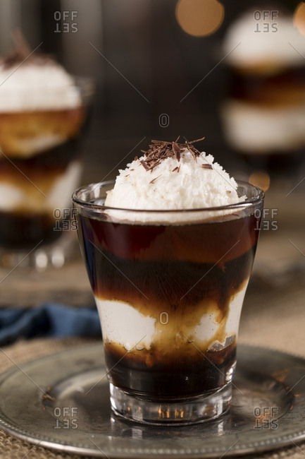 Affogato served with vanilla ice cream and topped with whipped cream and chocolate shavings