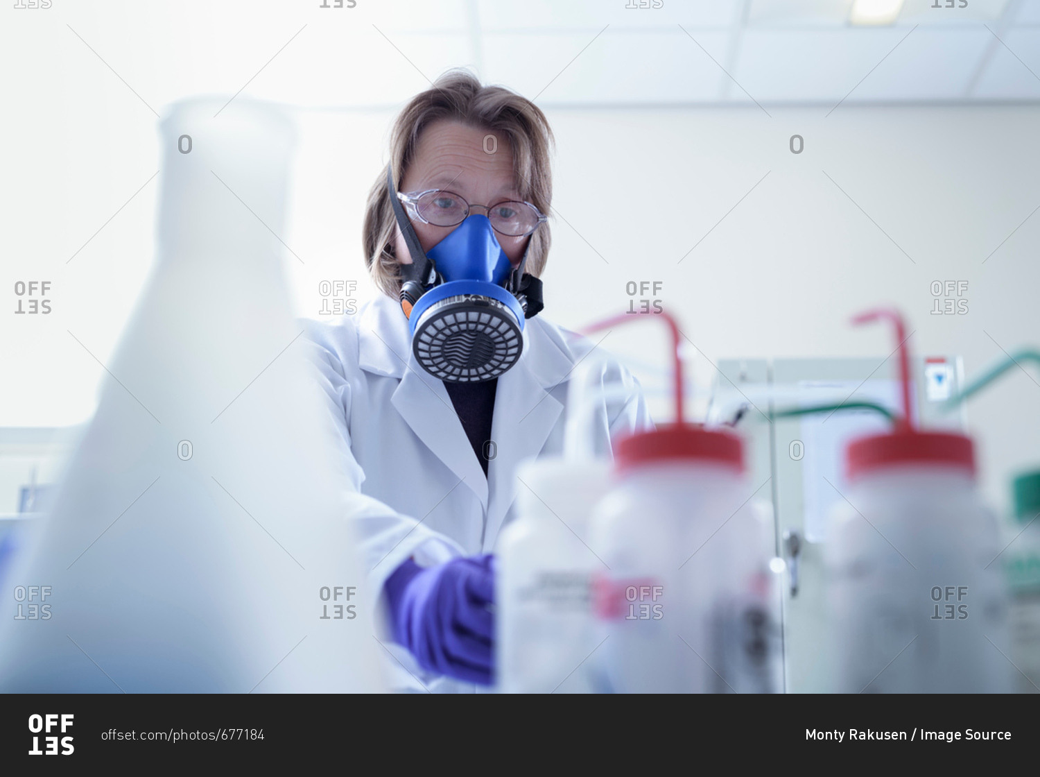 Scientist in breathing apparatus working in laboratory