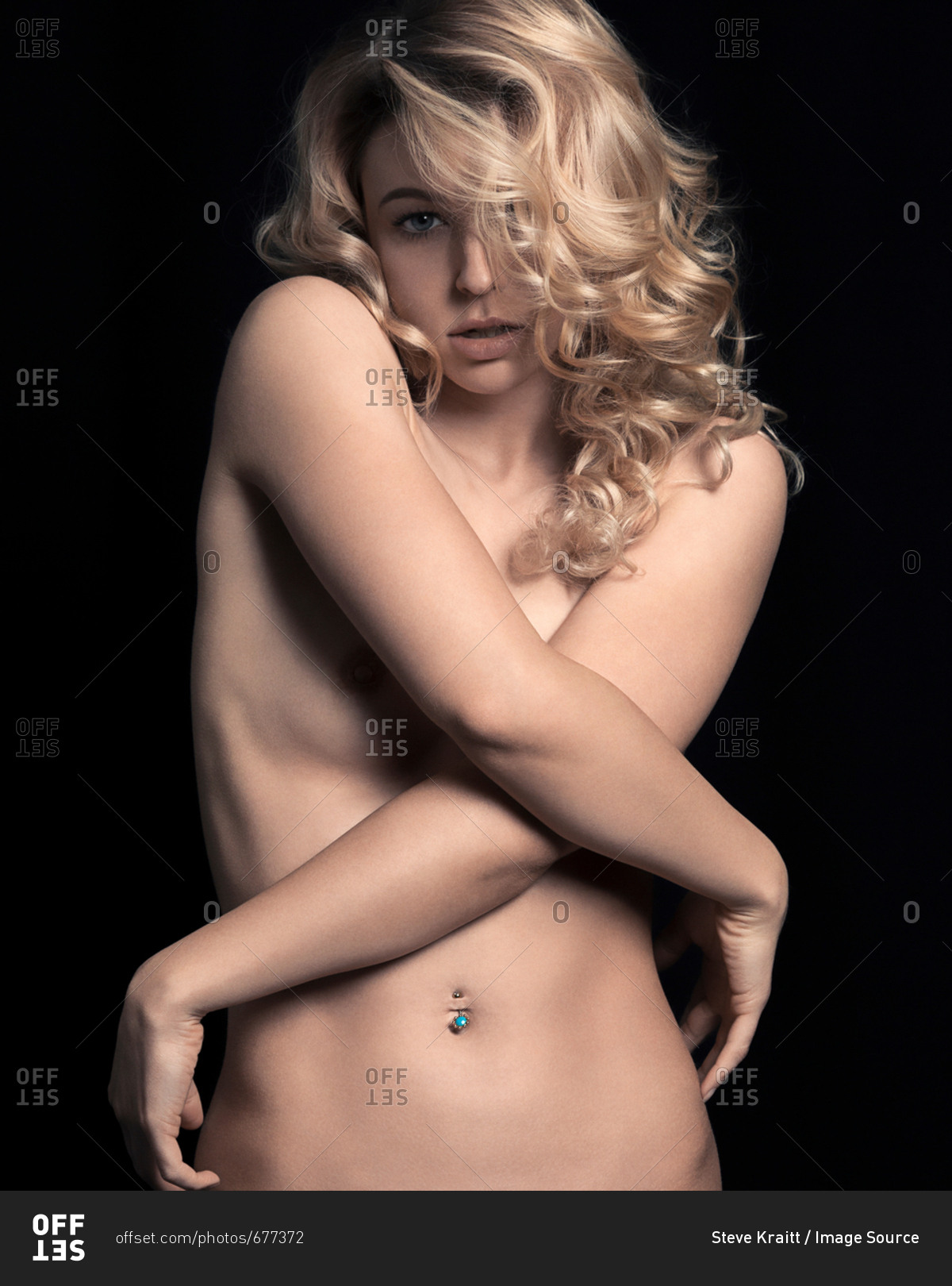 Portrait of semi nude mature woman with arms crossed,model