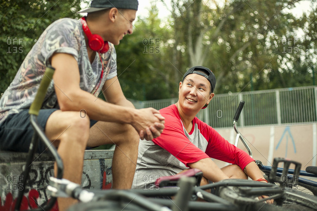 Young men with BMX bikes relaxing in BMX park, Budapest, Hungary