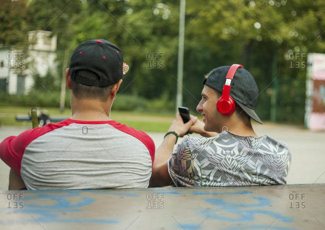 Young men with BMX bikes listening to music in BMX park, Budapest, Hungary