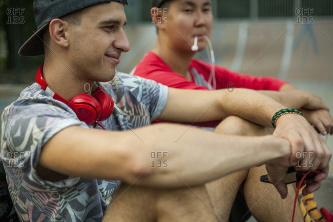 Young men with BMX bikes listening to music in BMX park, Budapest, Hungary