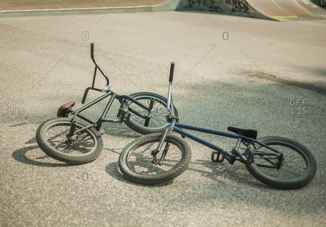 Two BMX bikes lying on their sides in BMX park, Budapest, Hungary