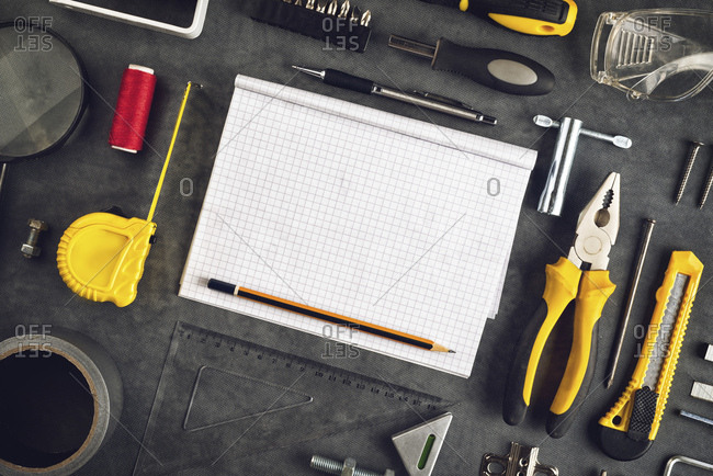 Assorted Do It Yourself tools and notebook as copy space.