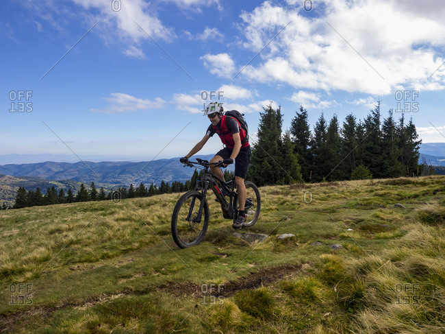 Mountain biker cycling on single trail on Ringelbuhlkopf, Alsace, France