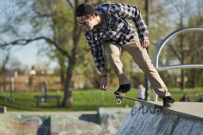 Young adult on skateboard dropping in on ramp, Montreal, quebec, canada