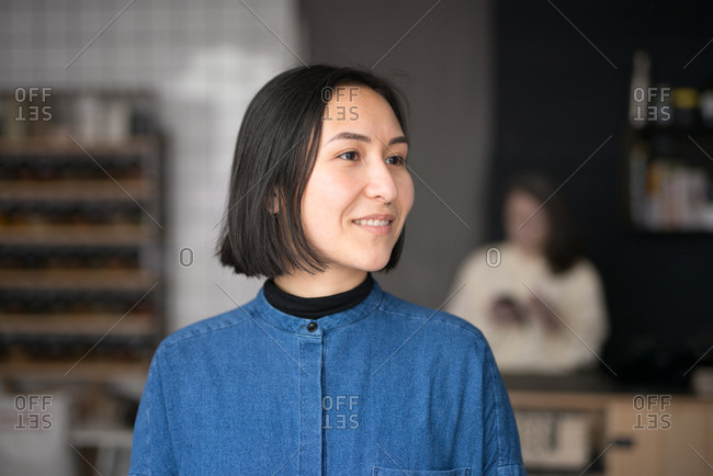 Young Asian woman in a grocery store looking away