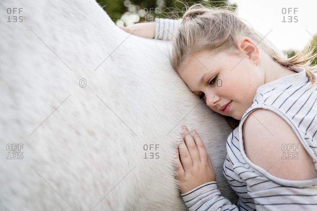 Girl embracing horse