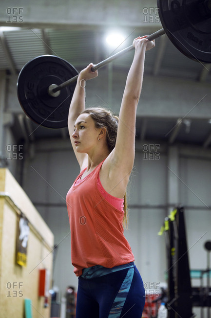 Pretty fit woman with barbell