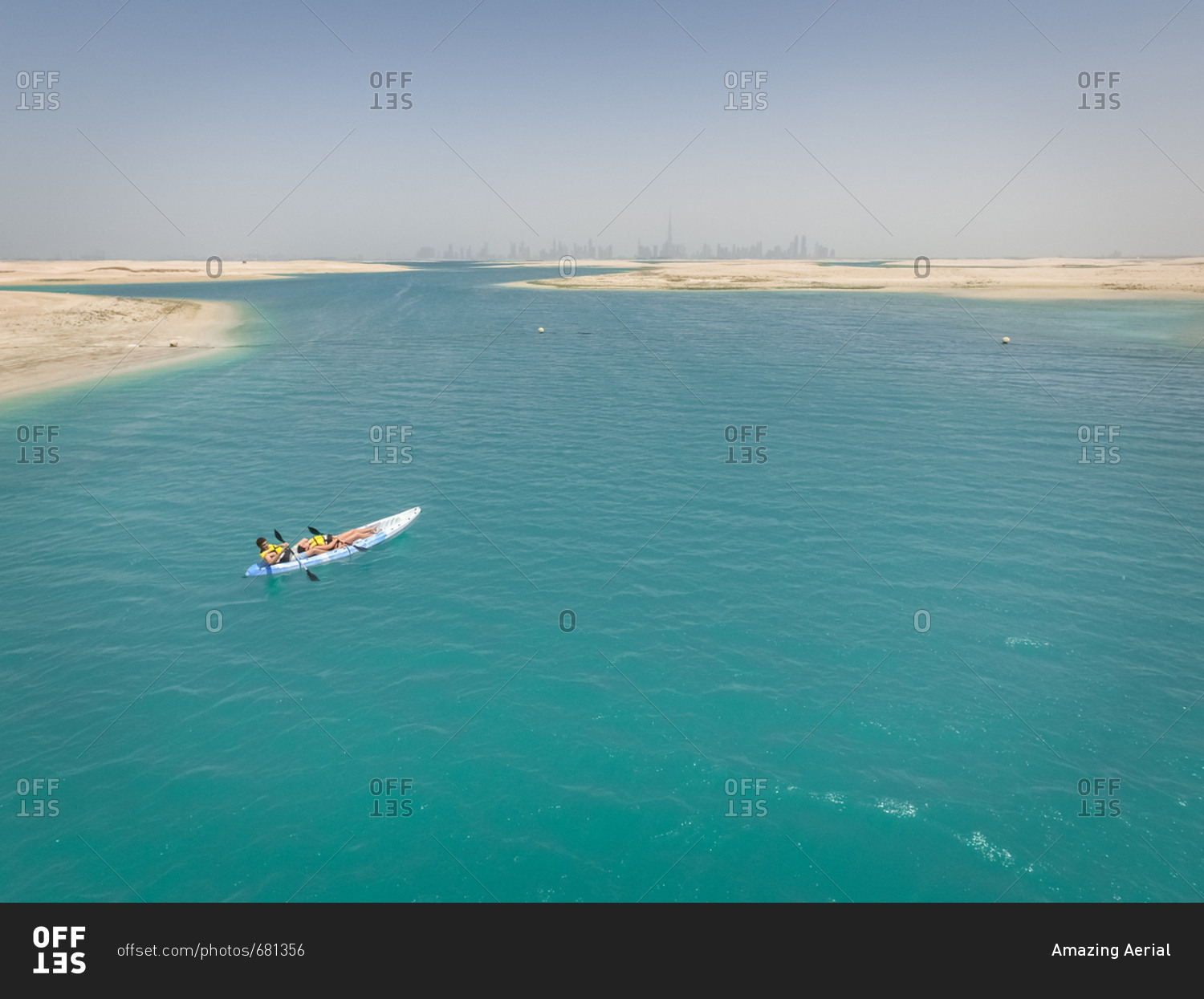 Aerial view of a couple kayaking in the middle of The world islands in Dubai, United Arab Emirates.