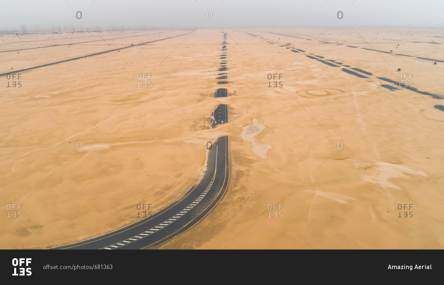 Aerial view of highway covered with sand in the desert of Dubai, United