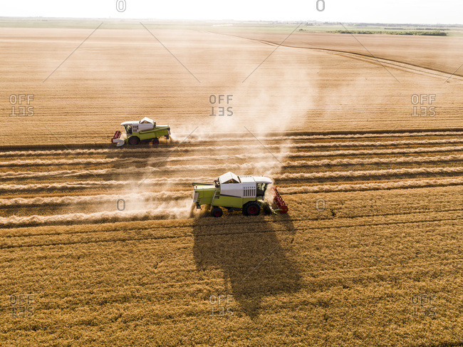 Serbia- Vojvodina. Combine harvester on a field of wheat- aerial view