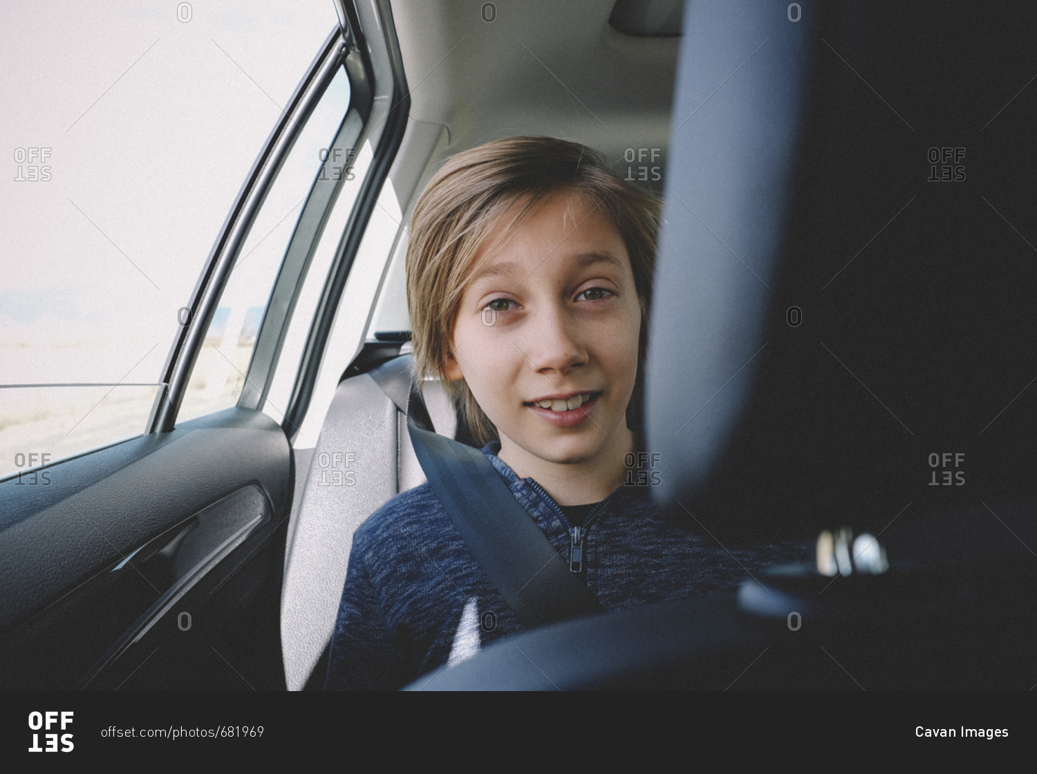 Portrait of smiling boy traveling in car
