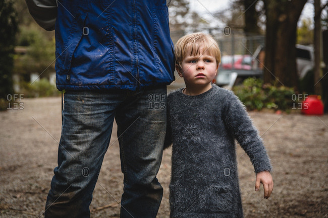 Boy holding father's leg