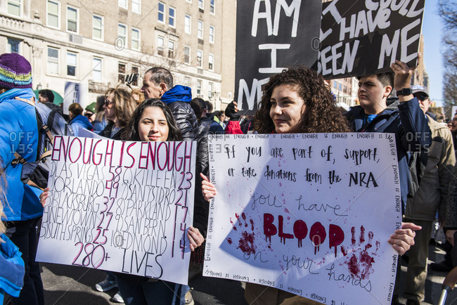 New York City, NY, USA - March 24, 2018: Young girls holding up hand written signs against gun violence at March For Our Lives 2018 demonstration