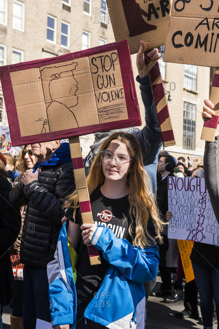 New York City, NY, USA - March 24, 2018: Young girl holding up sign reading "Stop gun violence" at March For Our Lives 2018 demonstration