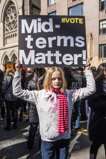 New York City, NY, USA - March 24, 2018: Young girl displaying sign reading "mid-terms matter" at March For Our Lives 2018 demonstration