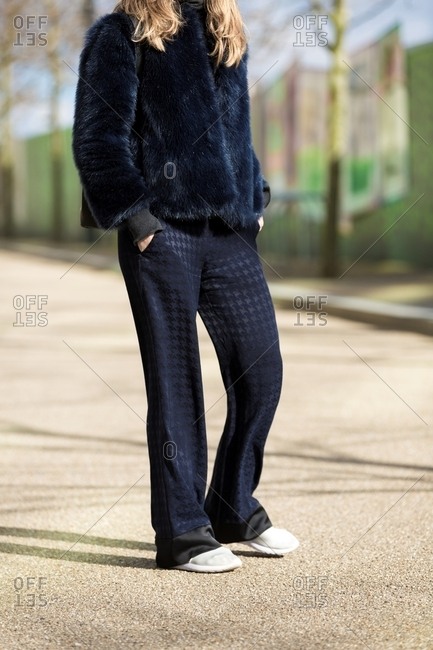 Woman with hands in pockets wearing short faux fur coat
