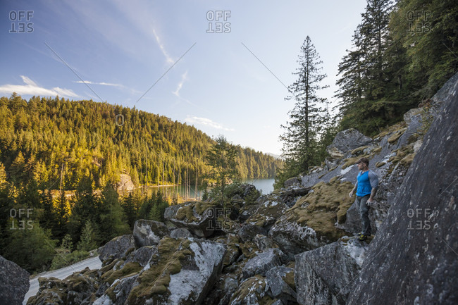 Man looking at view while bouldering near Elbow Lake in Fraser Valley, Harrison Mills, British Columbia, Canada