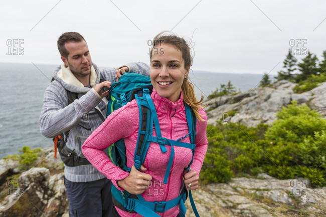 Couple hiking on cloudy morning on Great Head in Acadia National Park, Maine, USA