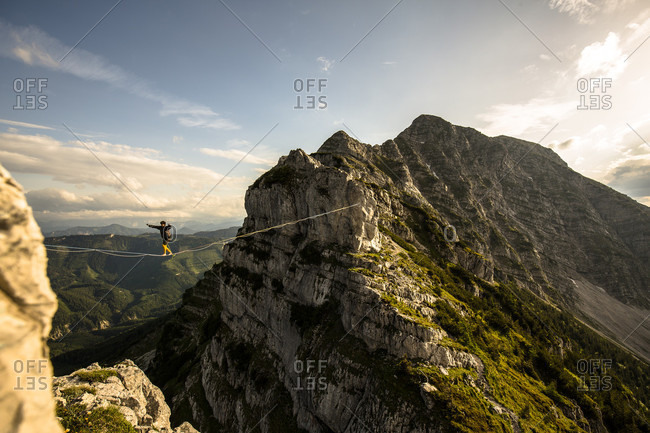 Man highlining on tightrope in Lower Alps, Lower Austria, Austria