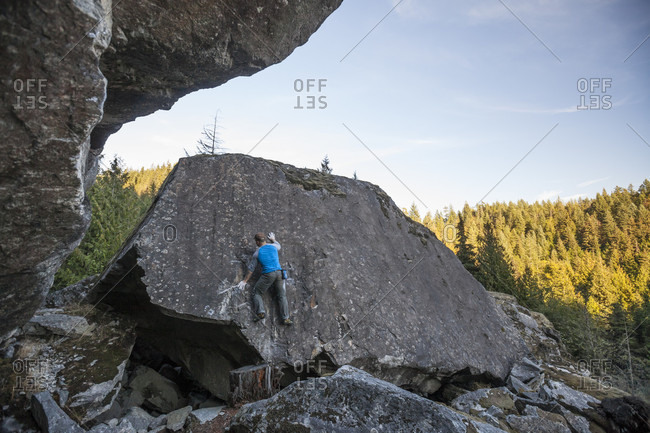 Climber bouldering near Elbow Lake in Fraser Valley, Harrison Mills, British Columbia, Canada
