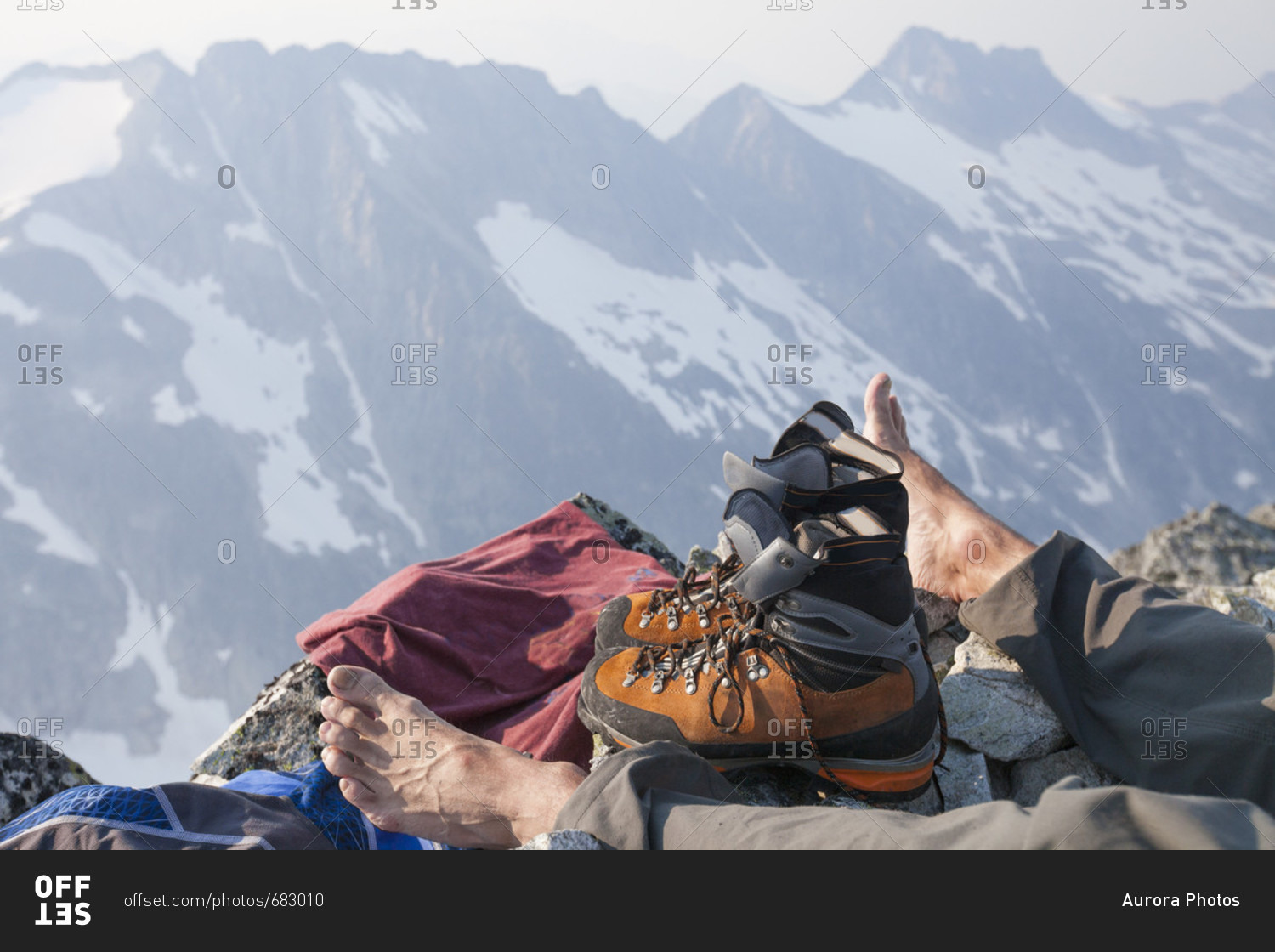 Hiker resting after reaching top of Ashlu Mountain in Coast Mountain Range, Squamish, British Columbia, Canada