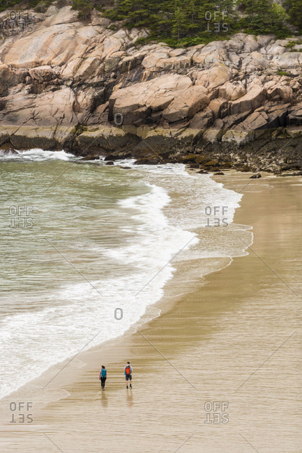 High angle view of couple walking on Sand Beach during daytime, Acadia National Park, Maine, USA