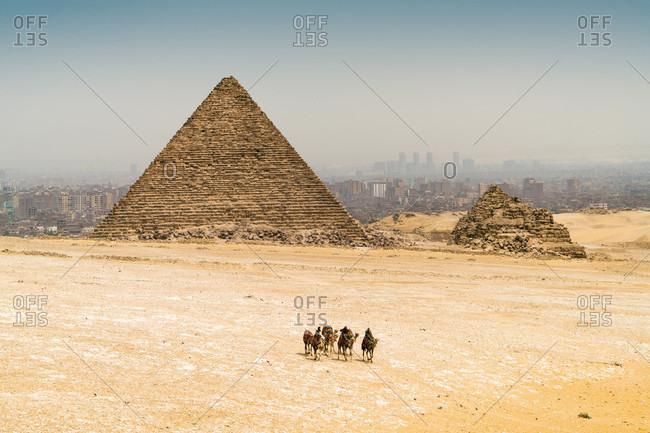 Pyramids of Giza with camels and desert in foreground,  Cairo, Egypt