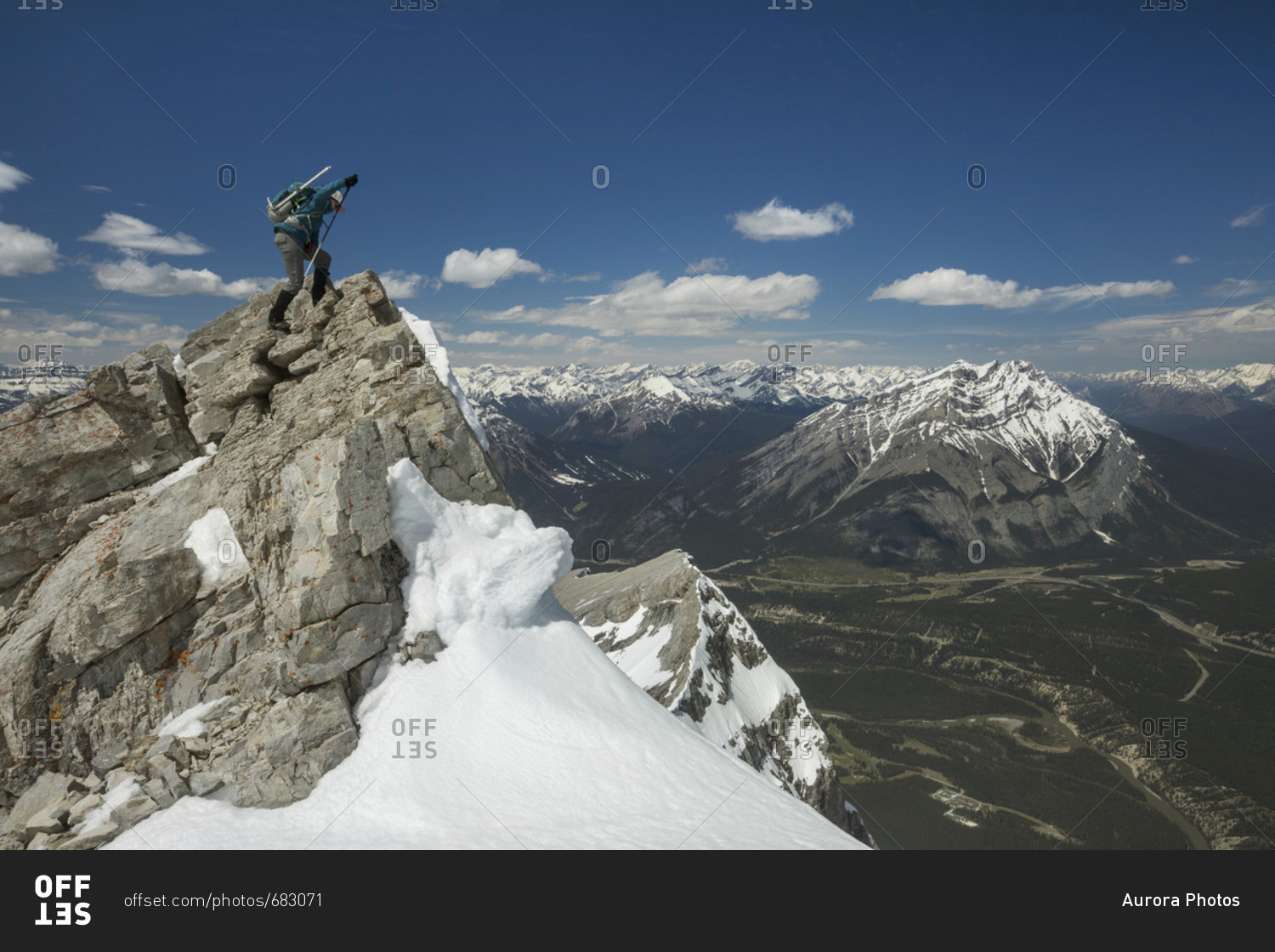 Mountain climber at summit of Mount Rundle, Banff National Park