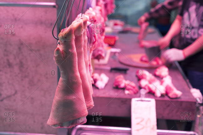 Raw meat on hooks in Hong Kong butcher shop