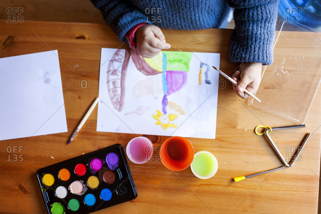 Child painting with watercolors