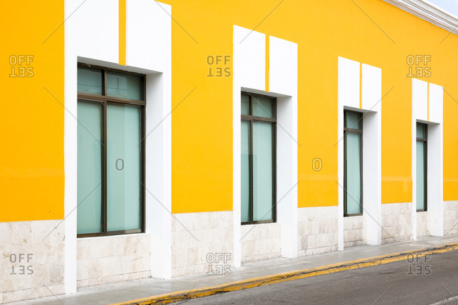 View of row of windows in bright yellow wall