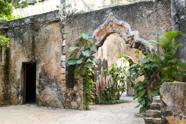 Moorish archways leading through weathered walls of estate