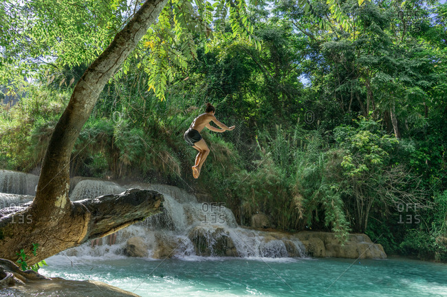 Man jumping to turquoise water
