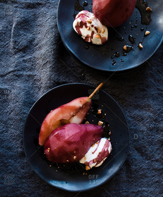 Halved poached pears stained with win sauce from above