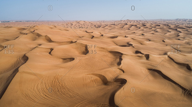 Aerial view of people driving quad bikes in the sand dunes of Al Bedayer desert in Sharjah, UAE