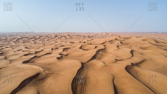 Aerial view of people driving quad bikes in the sand dunes of Al Bedayer desert in Sharjah, UAE