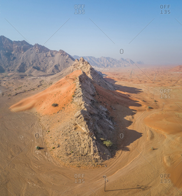 Aerial view of a rocky peak mountains in the middle of Sharjah desert, UAE