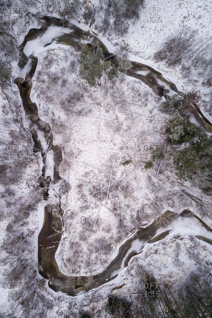 Aerial view of Vaana Jogi serpentine river surrounded by snow in winter in Estonia
