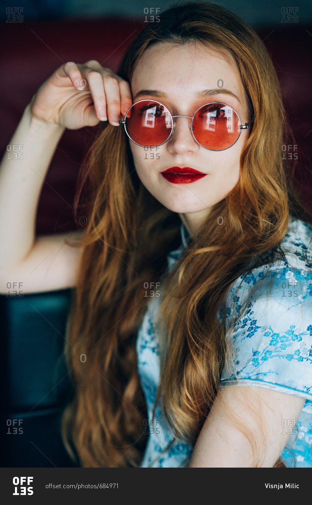 Portrait of beautiful red hair girl wearing retro glasses and wearing blue  chinese dress stock photo - OFFSET